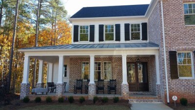 Snaplock onyx metal roof on a brick-walled house