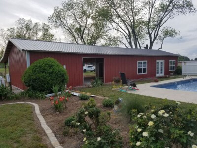 Pool shed with cinnamon metal walls and granite roofing