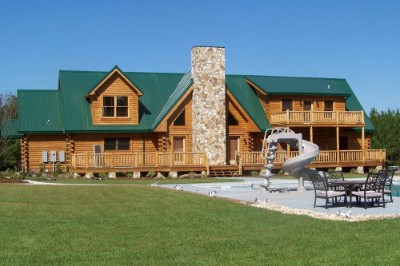 Log cabin with a forest green rib roofing