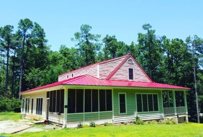 House with metal roofing in the color of old farm red