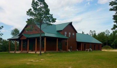 Dark brown house with green metal roofing
