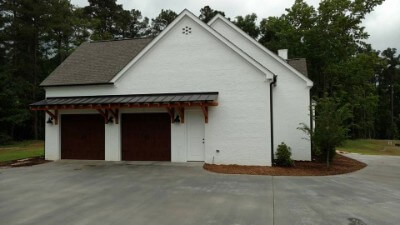 Metal roof awning over garage doors